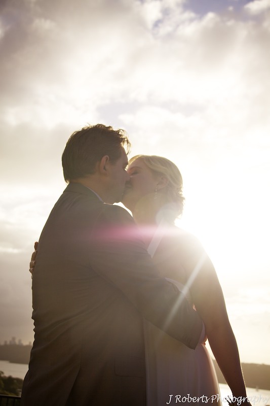 Bride & Groom kissing in the sunset - wedding photography sydney